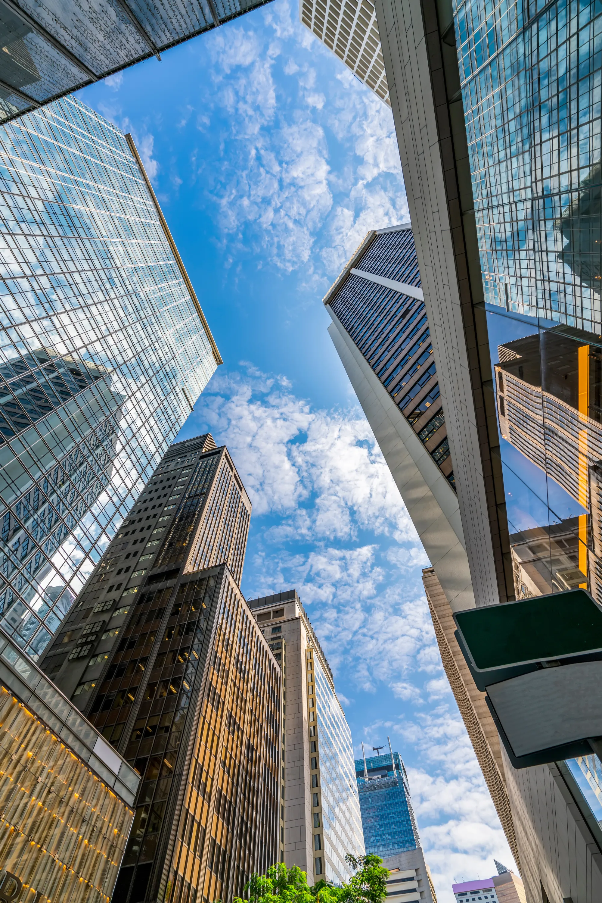 A perspective view of skyscrapers stretching upward, framed by a vast expanse of sky